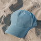 Blue cap on sand