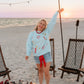 woman at bonfire wearing firework sweatshirt 