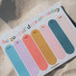 Colorful daily planner calendar on a sandy surface