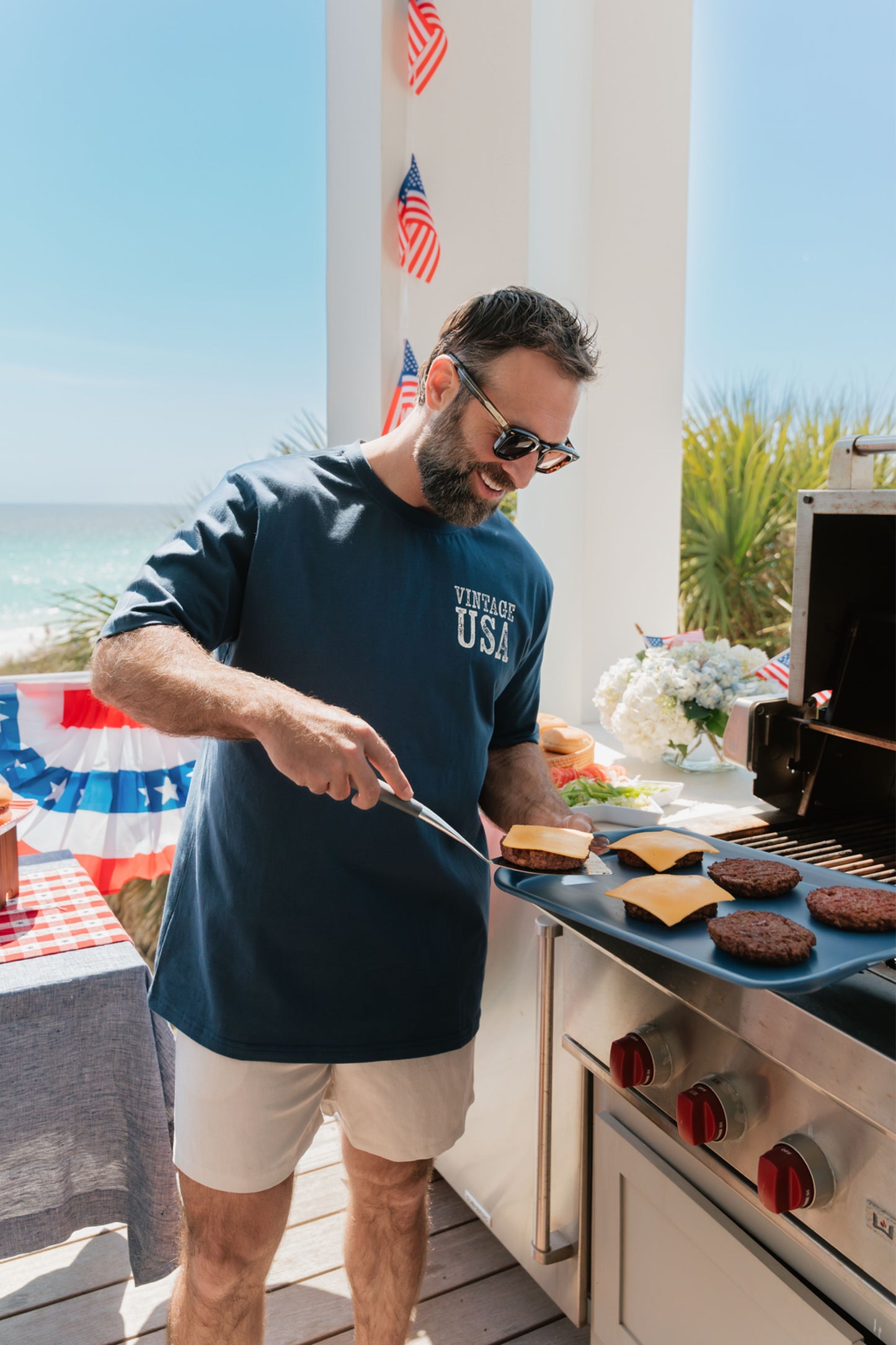 Man grilling outdoors with a scenic background