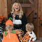 woman giving out candy to kids in costume