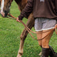 A person wearing a brown sweatshirt with 'DRIVING FULLY CO.' printed in white, walking alongside a brown horse on a green grassy field.