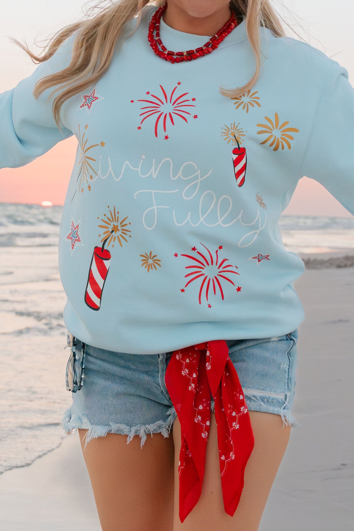 woman wearing blue sweatshirt with shorts and a scarf 