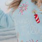 Light blue sweatshirt with red and gold firework designs and 'Living Fully' text.