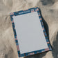 Notebook with decorative cover on sand