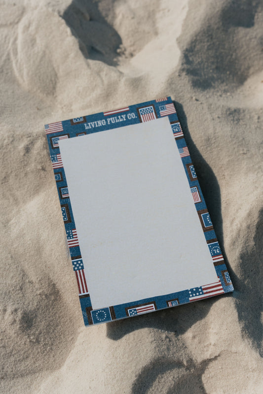 Notebook with decorative cover on sand