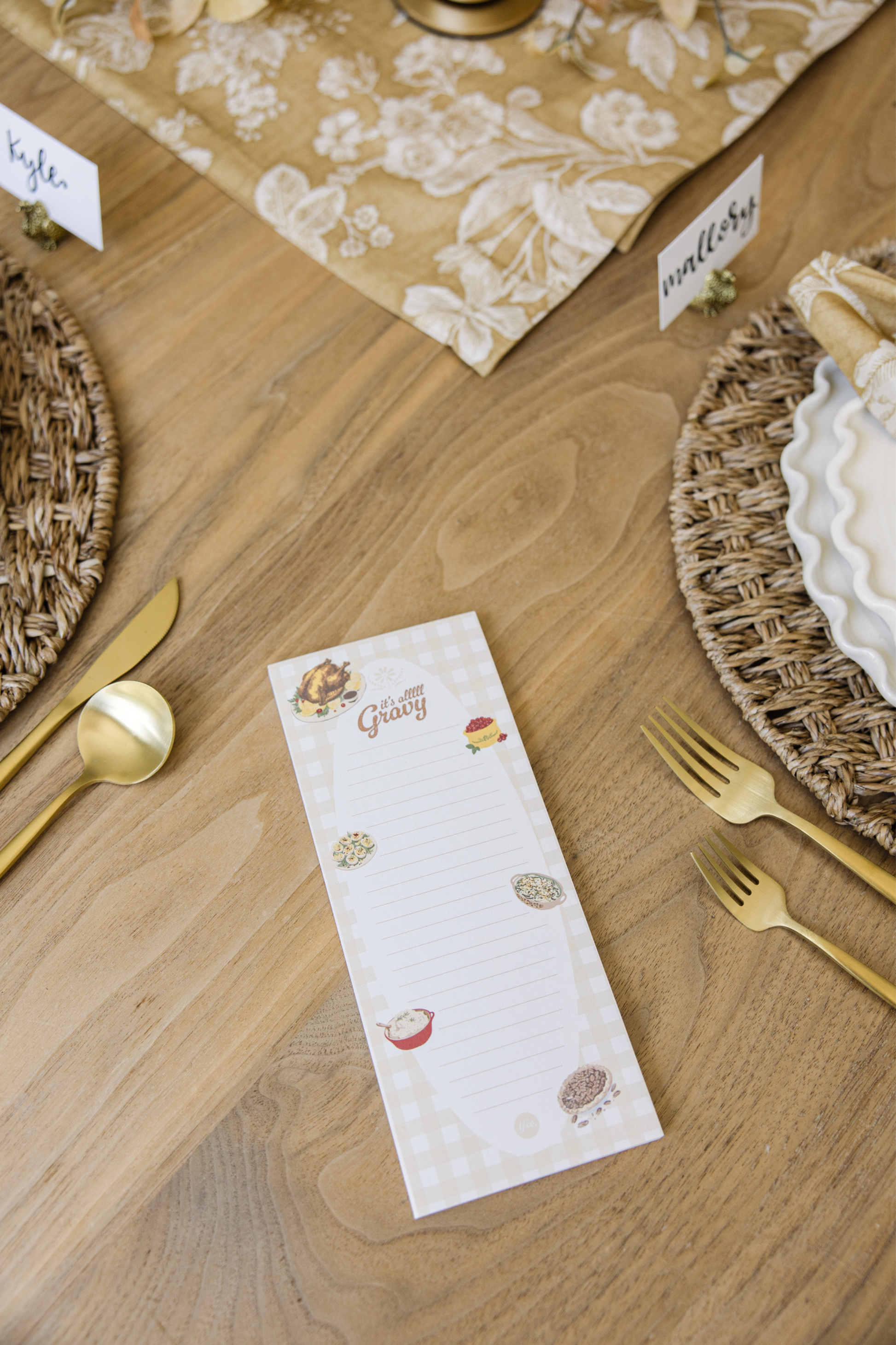 Table setting with a decorative place card on a wooden table.
