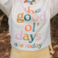 Person wearing a sweatshirt with 'The good ol' days are today' text in colorful letters.
