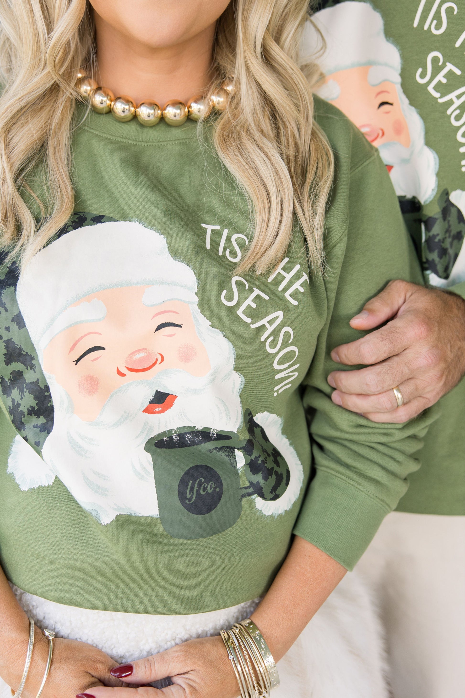 Green sweatshirt with a cartoon Santa Claus design and 'Tis the Season text.