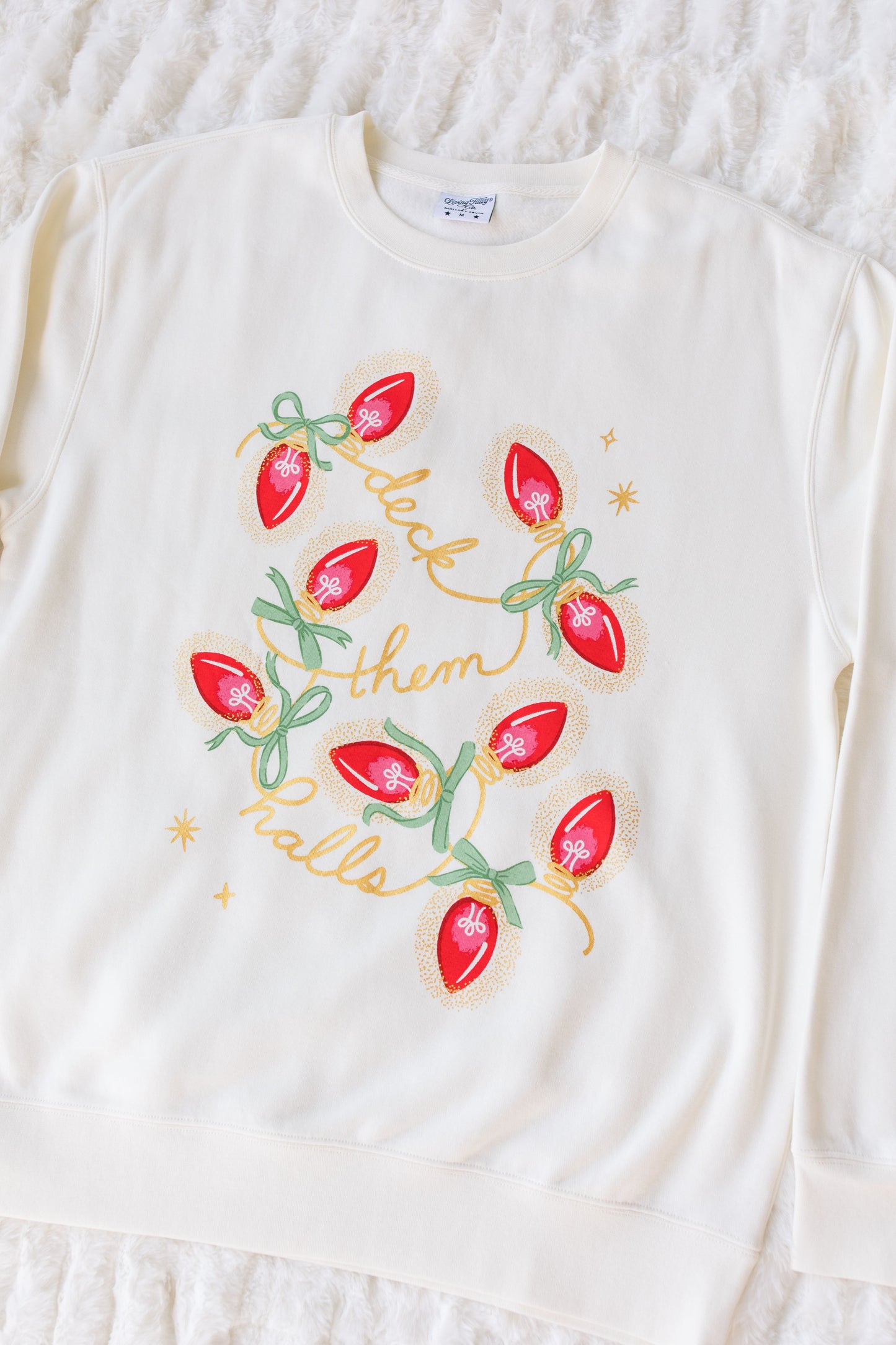 White long-sleeve sweatshirt with Christmas-themed design on a textured white background