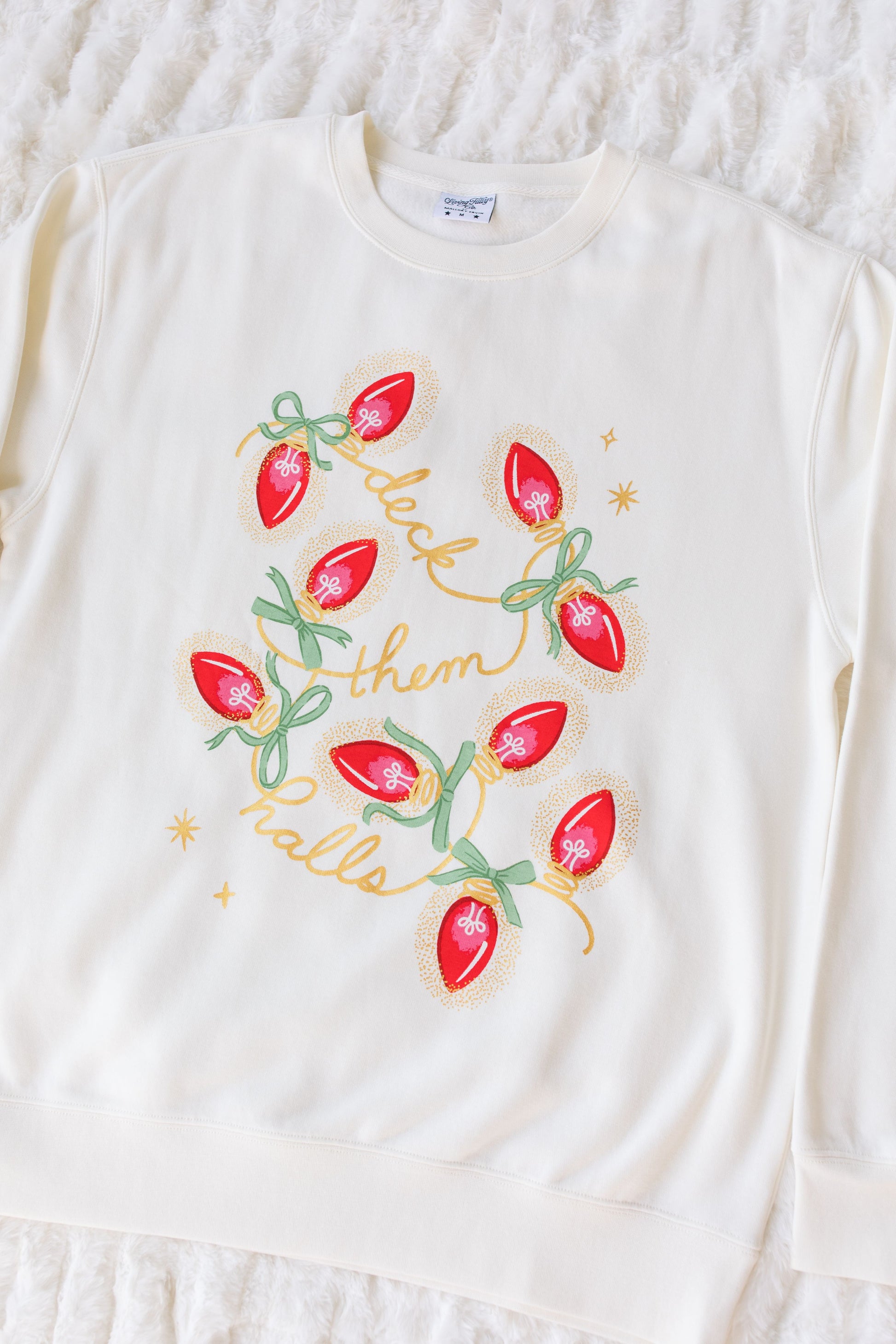 White long-sleeve sweatshirt with Christmas-themed design on a textured white background