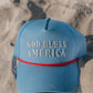 blue hat with god bless america on the front on the beach 