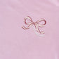 Pink sweatshirt with a bow design and text on a plain background