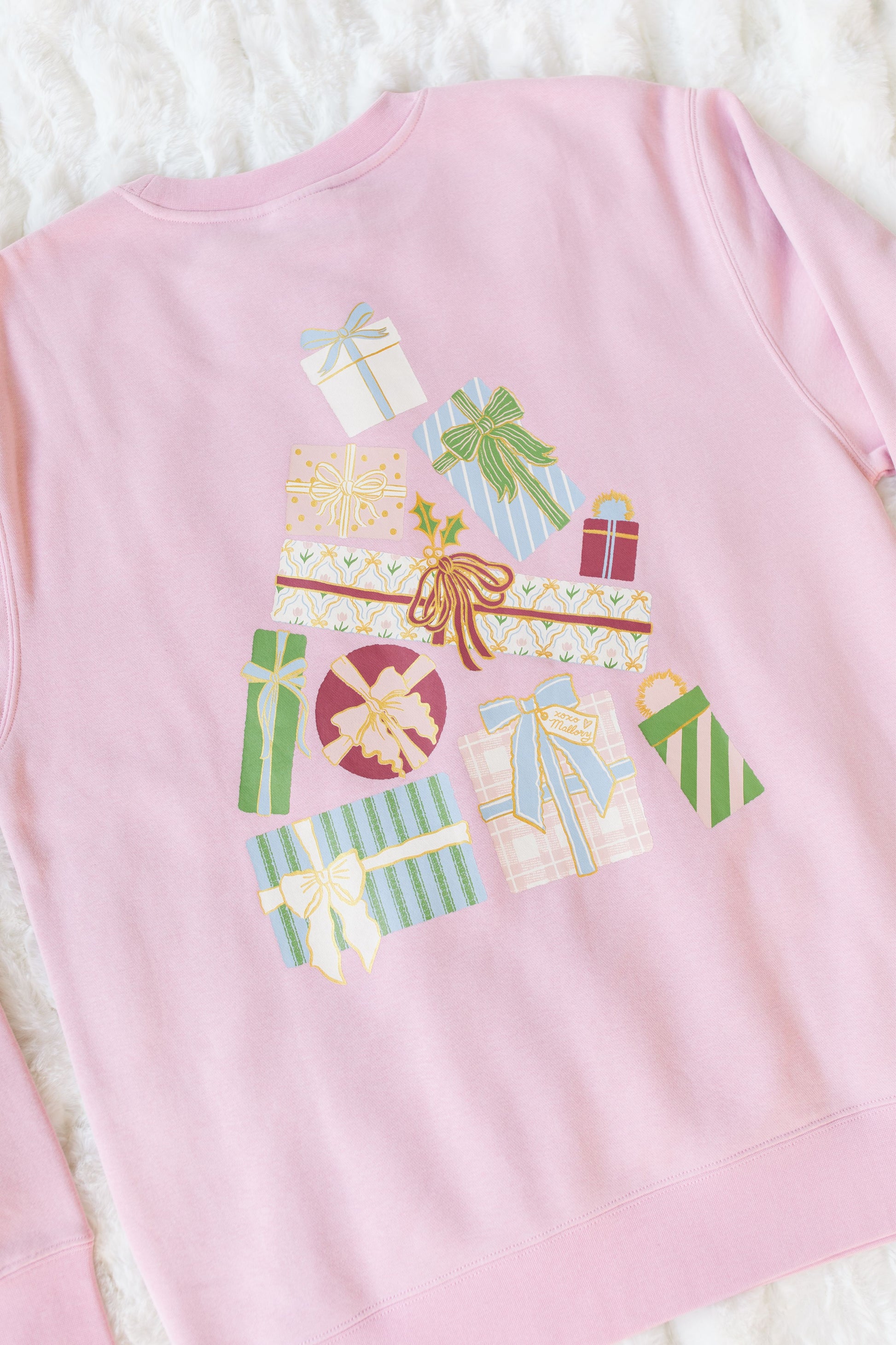 Pink sweatshirt with a colorful gift box design on a white background